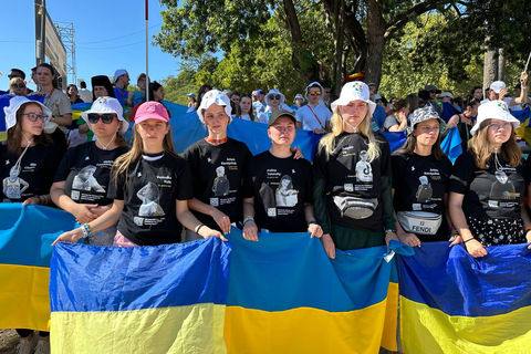Ukrainian youth wearing clothes with portraits of Ukrainian children killed by Russia join the Way of the Cross with the Pope